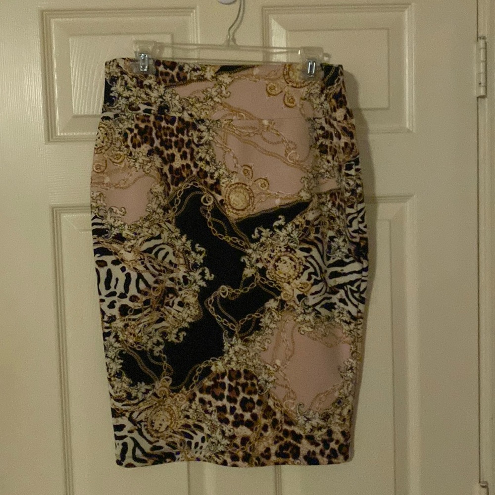 Size Lg, black, light pink, cream and gold. Like new. Pencil Skirt, split.